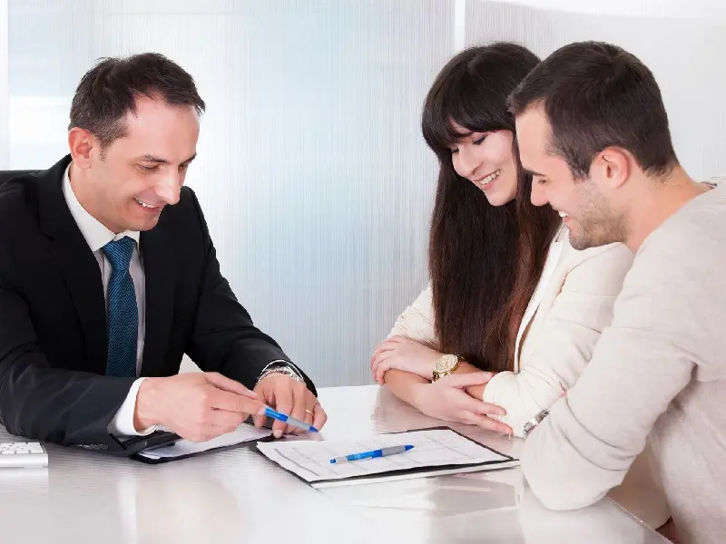 A man and two women sitting at a table.